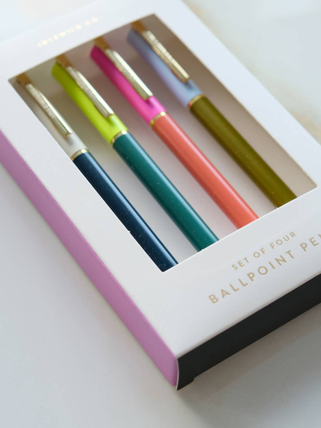 Close-up of Idlewild Co. Tokyo City Palette Pens, featuring navy, teal, coral and olive duo-toned ballpoint pens with metallic gold accents | Twentyseven Toronto