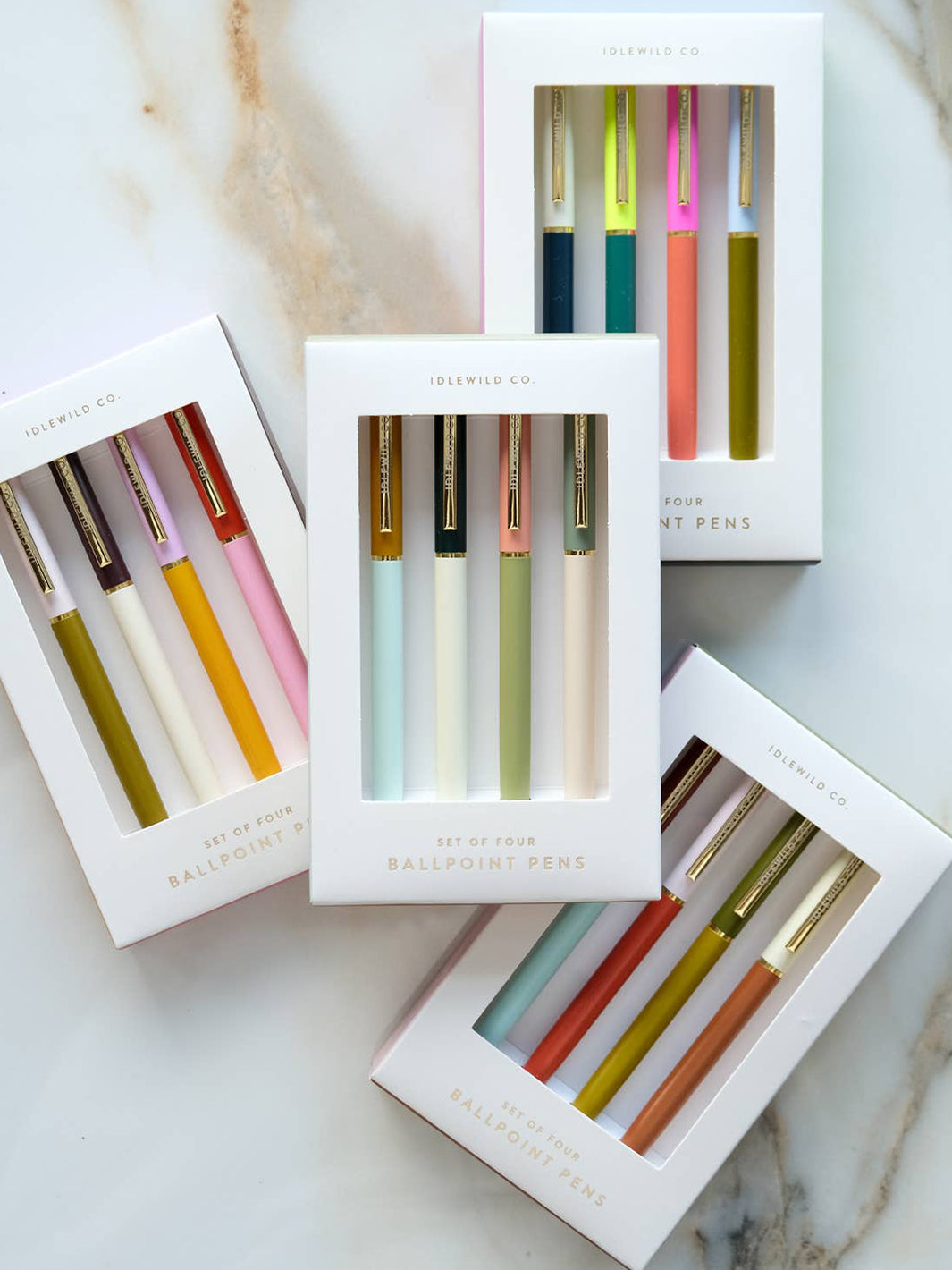 Four Idlewild Co. City Palette ballpoint pen sets displayed in white gift boxes, showcasing colourful pen combinations with gold hardware | Twentyseven Toronto