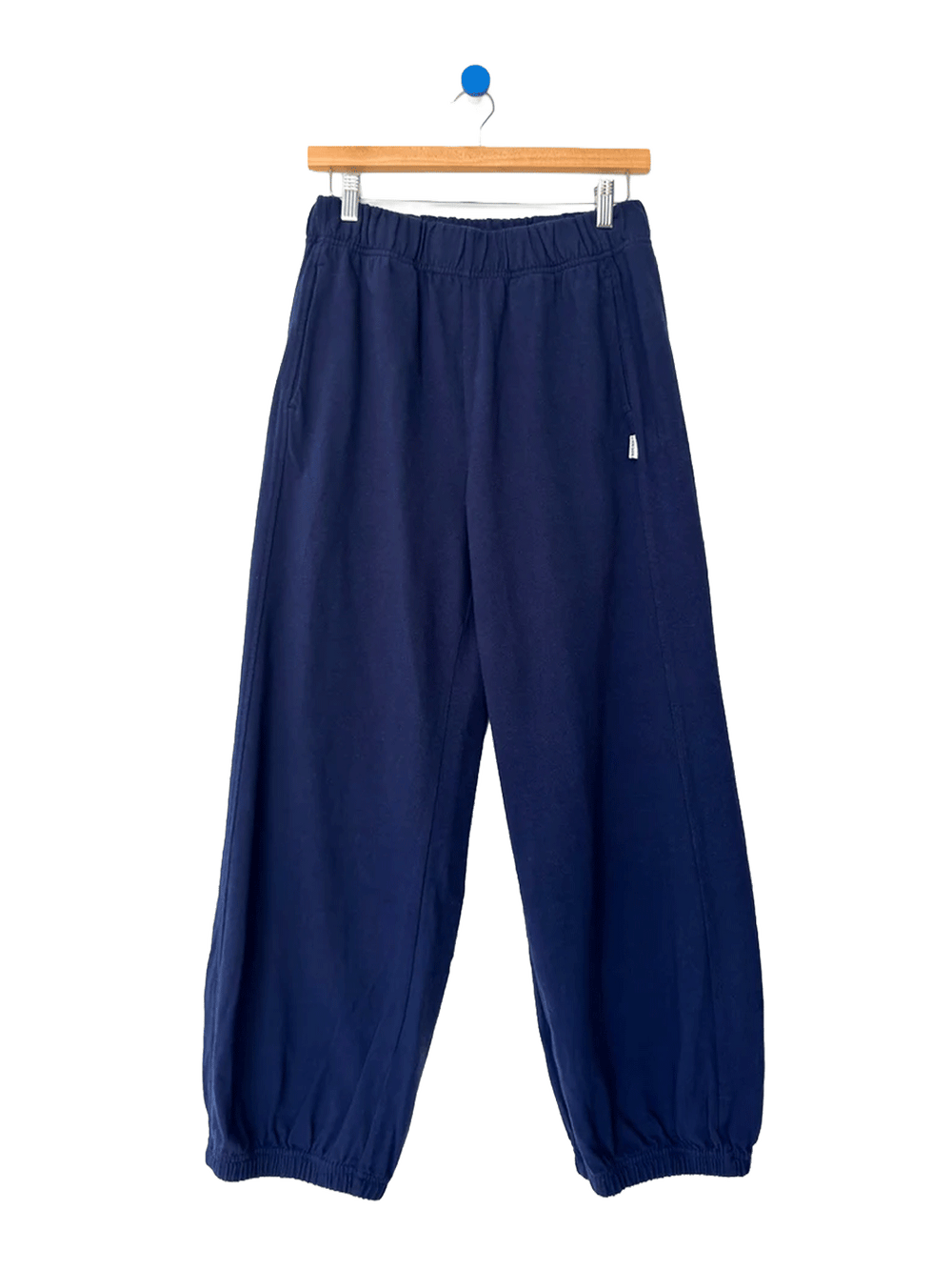 Le Bon Shoppe Balloon Pants in Midnight on a wooden hanger against a white background | Twentyseven Toronto