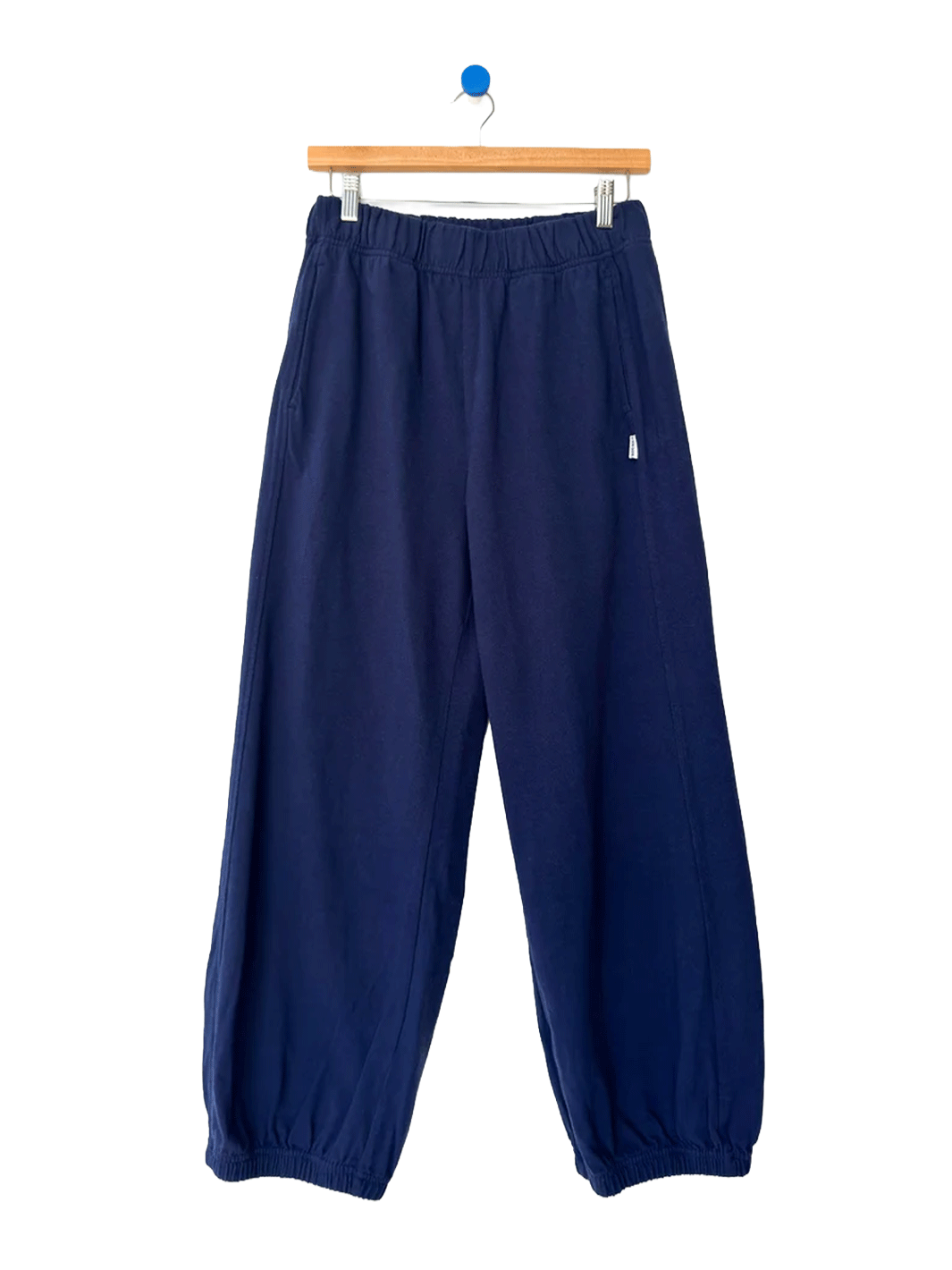 Le Bon Shoppe Balloon Pants in Midnight on a wooden hanger against a white background | Twentyseven Toronto
