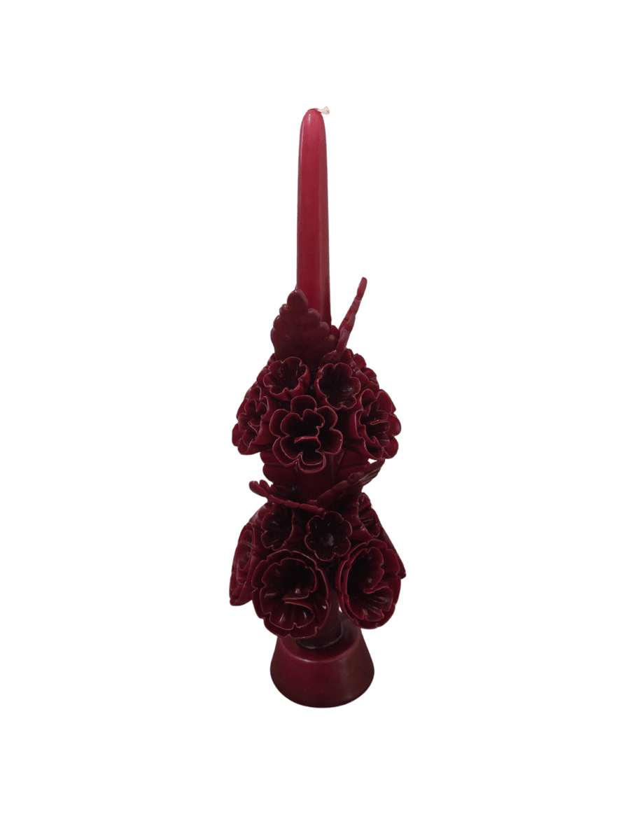 Dark red floral wax candle called the Banderilla Scaled Candle in Burgundy from Cereria de Jesus against a transparent background | Twentyseven Toronto