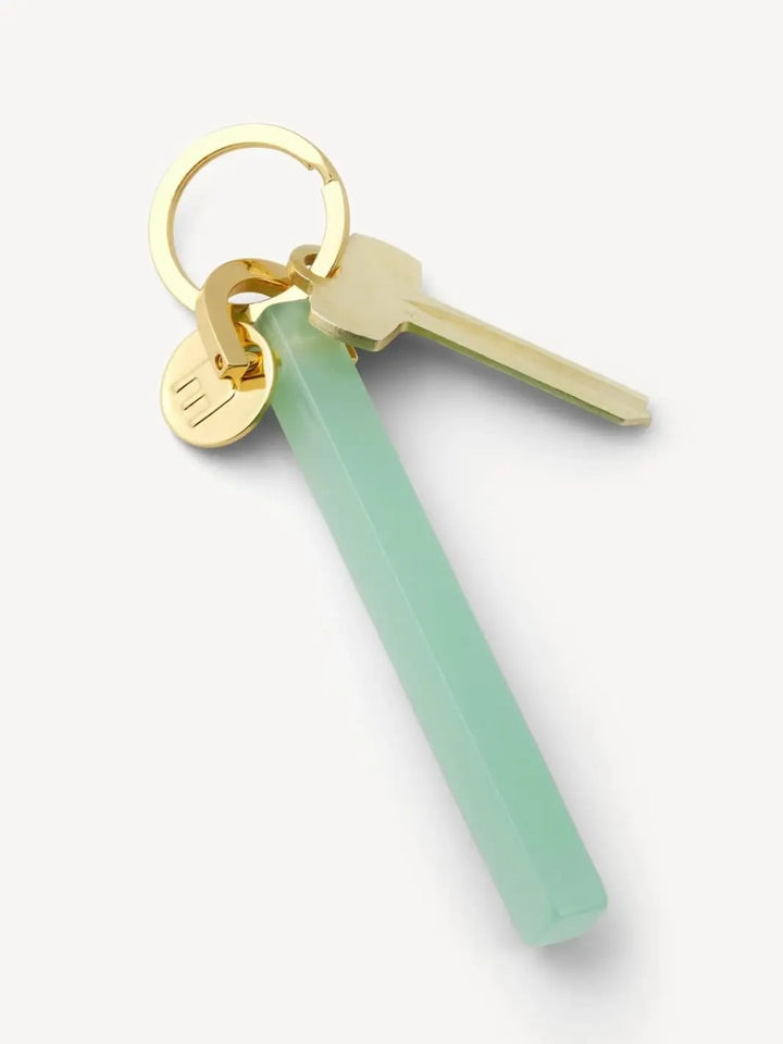 Gold and light green keychain from MACHETE | Twentyseven Toronto
