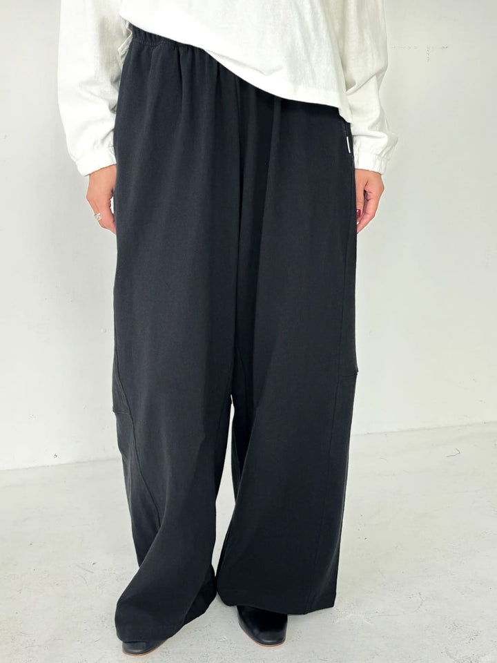 Person wearing wide-leg Bare Pants in 'Black' from Le Bon Shoppe and a white top on a white background | Twentyseven Toronto