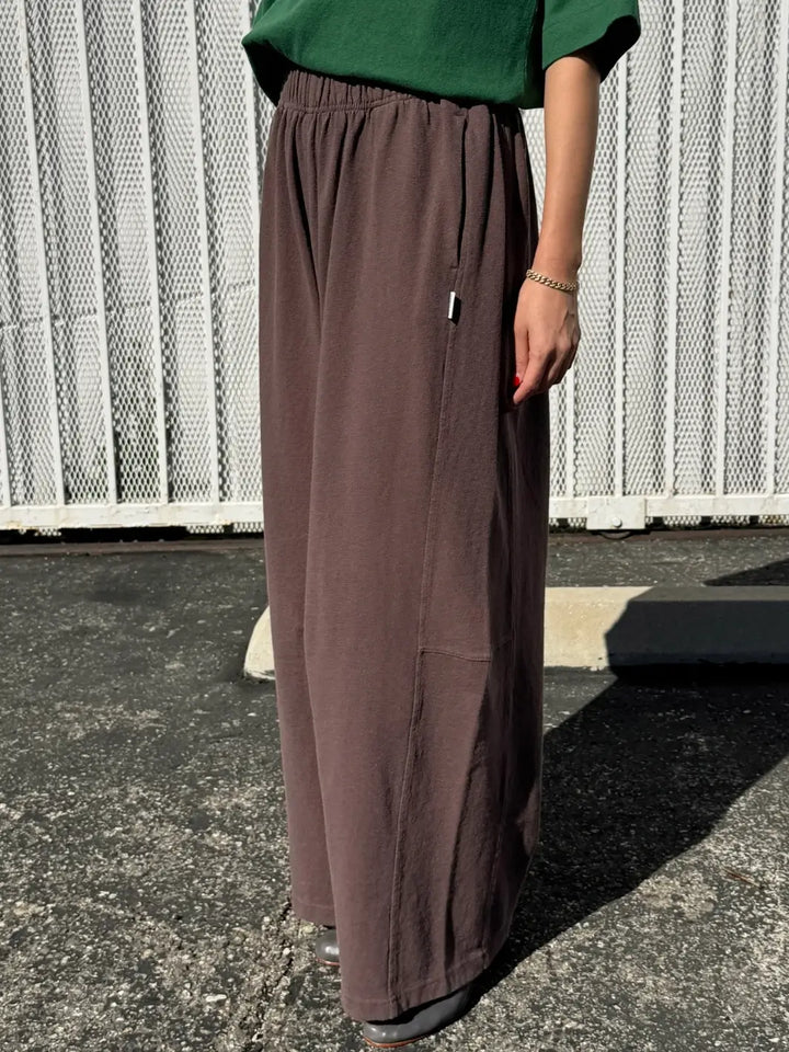 Person wearing dark brown wide-leg Bare Pants in 'Chocolate' from Le Bon Shoppe in an outside setting, side view | Twentyseven Toronto