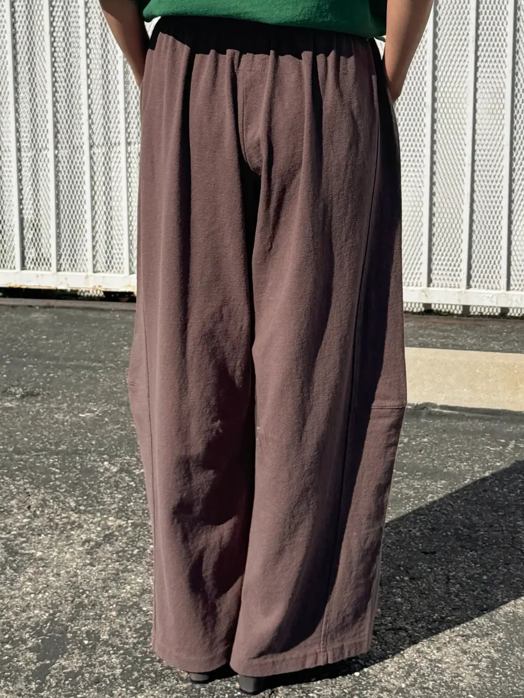 Person wearing dark brown wide-leg Bare Pants in 'Chocolate' from Le Bon Shoppe in an outdoor setting, close up | Twentyseven Toronto