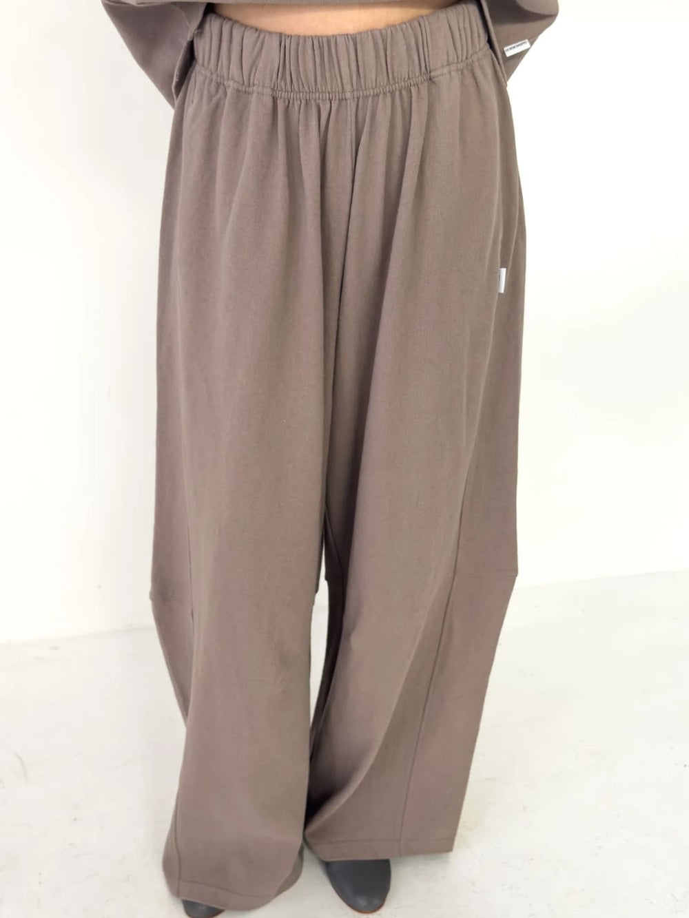 Person wearing light brown wide-leg Bare Pants in 'Mushroom' from Le Bon Shoppe on a white background | Twentyseven Toronto