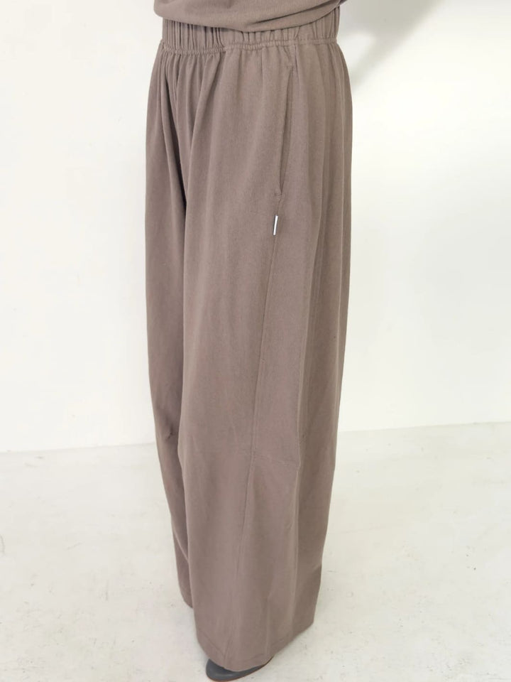 Person wearing light brown wide-leg Bare Pants in 'Mushroom' from Le Bon Shoppe on a white background, side view | Twentyseven Toronto