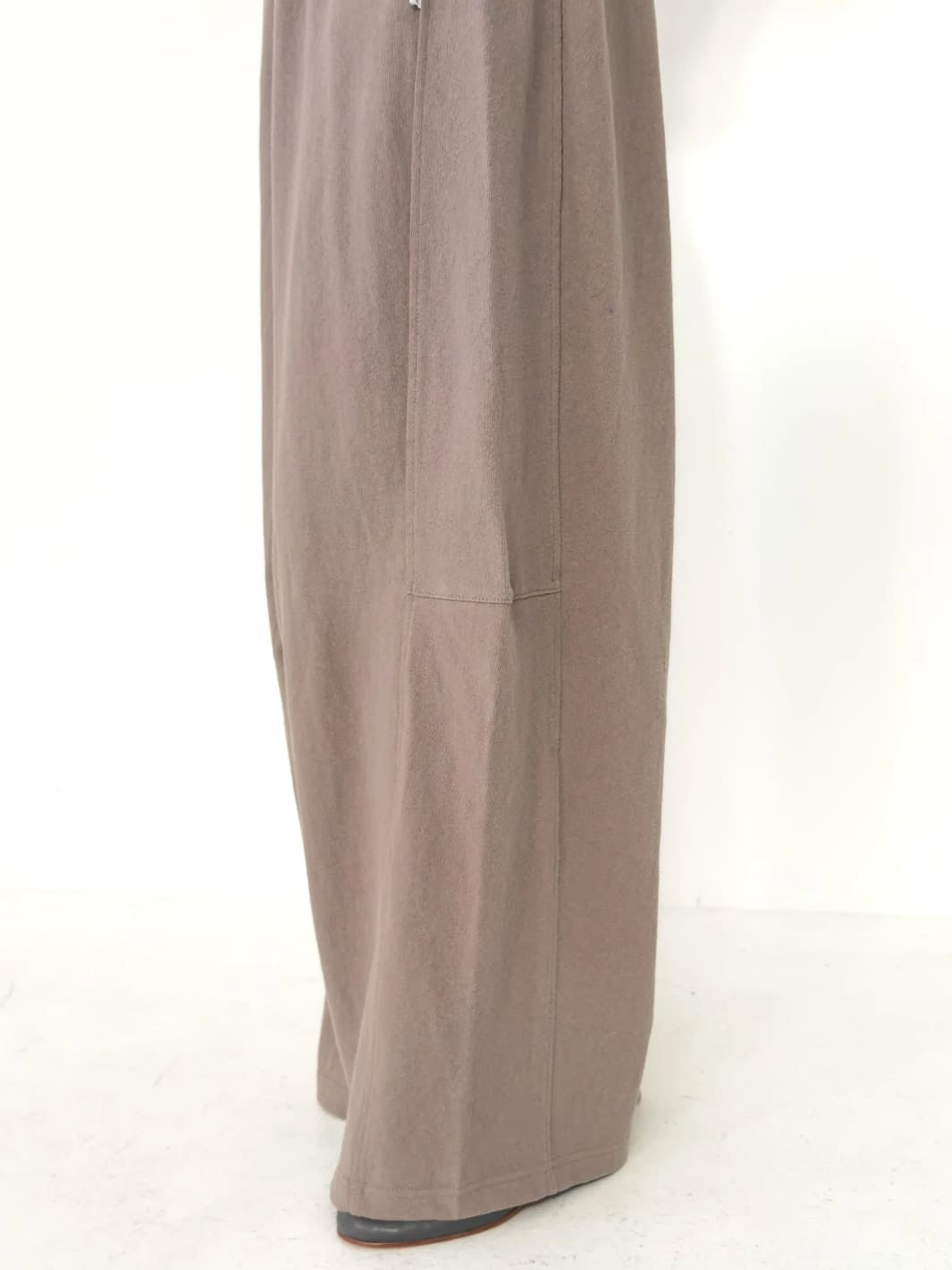 Person wearing light brown wide-leg Bare Pants in 'Mushroom' from Le Bon Shoppe on a white background, close up | Twentyseven Toronto