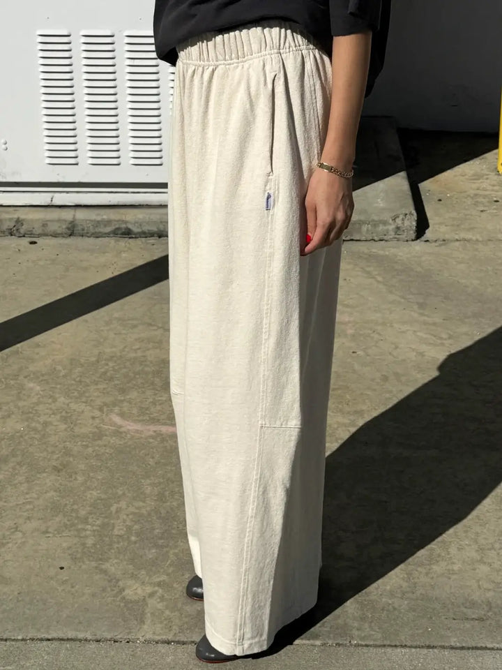 Person wearing cream wide-leg Bare Pants in 'Naturel' from Le Bon Shoppe in an outdoor setting, side view | Twentyseven Toronto
