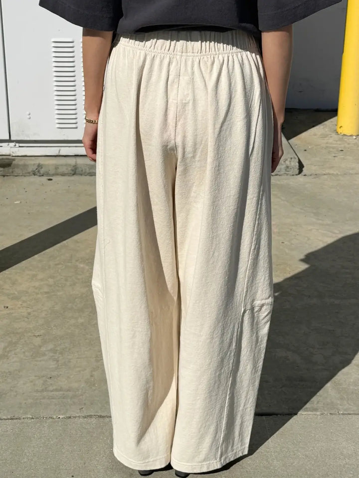 Person wearing cream wide-leg Bare Pants in 'Naturel' from Le Bon Shoppe in an outdoor setting, back view | Twentyseven Toronto