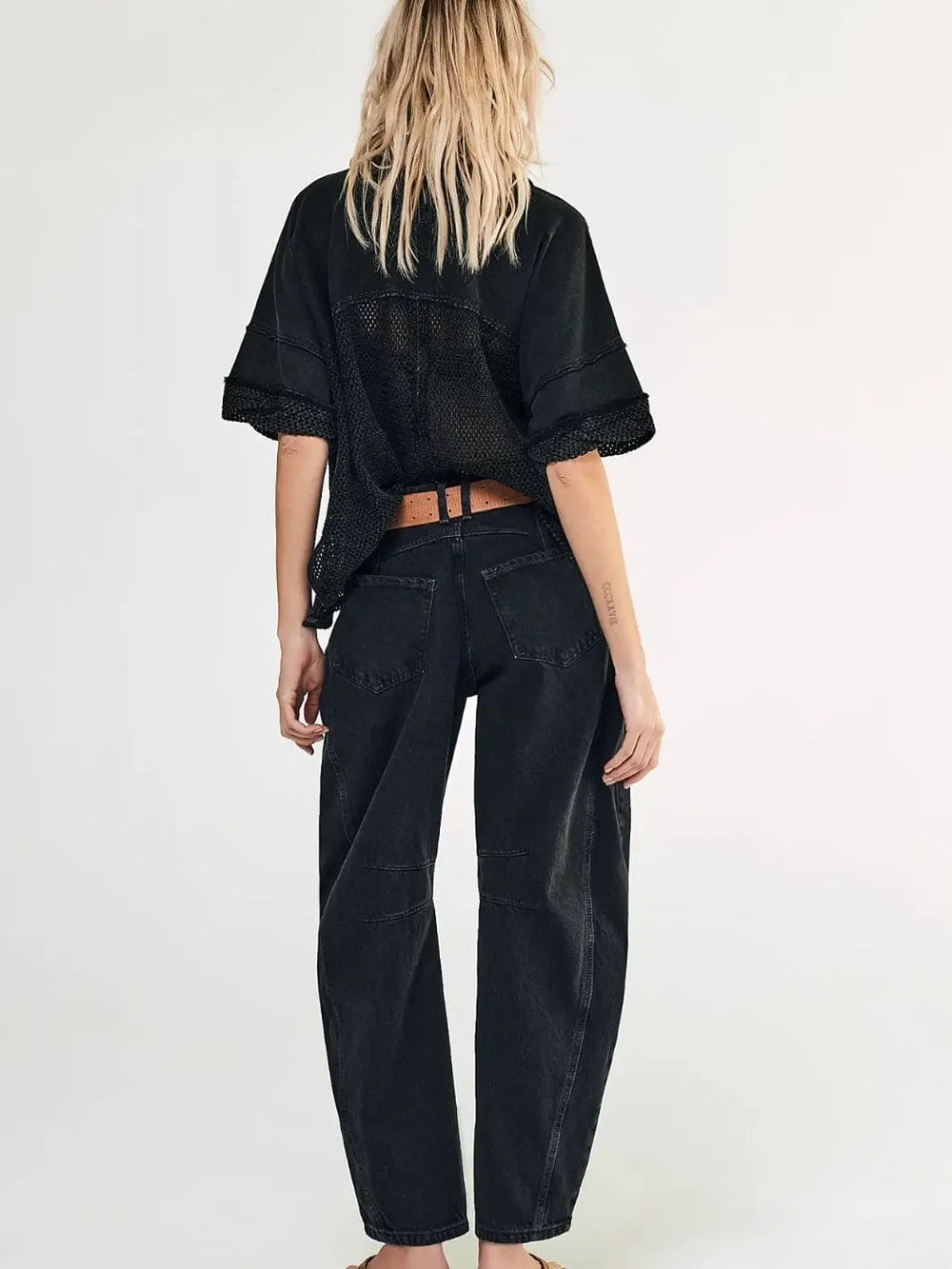 A view from behind shows the loose fit, curved leg shape, and pocket placement of the Free People Good Luck Mid-Rise Barrel Jeans - Soundwave | Twentyseven Toronto