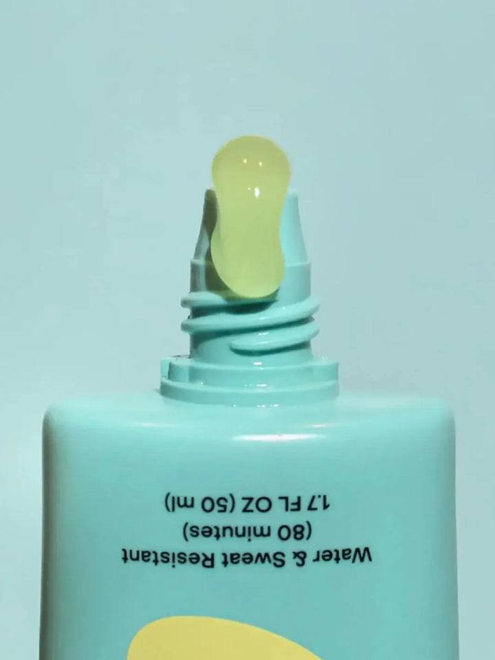 A close-up shot shows a clear, dollop of gel squeezing out from the tip of an upside-down Bask Suncare Daily Invisible Gel SPF 40 Sunscreen tube | Twentyseven Toronto