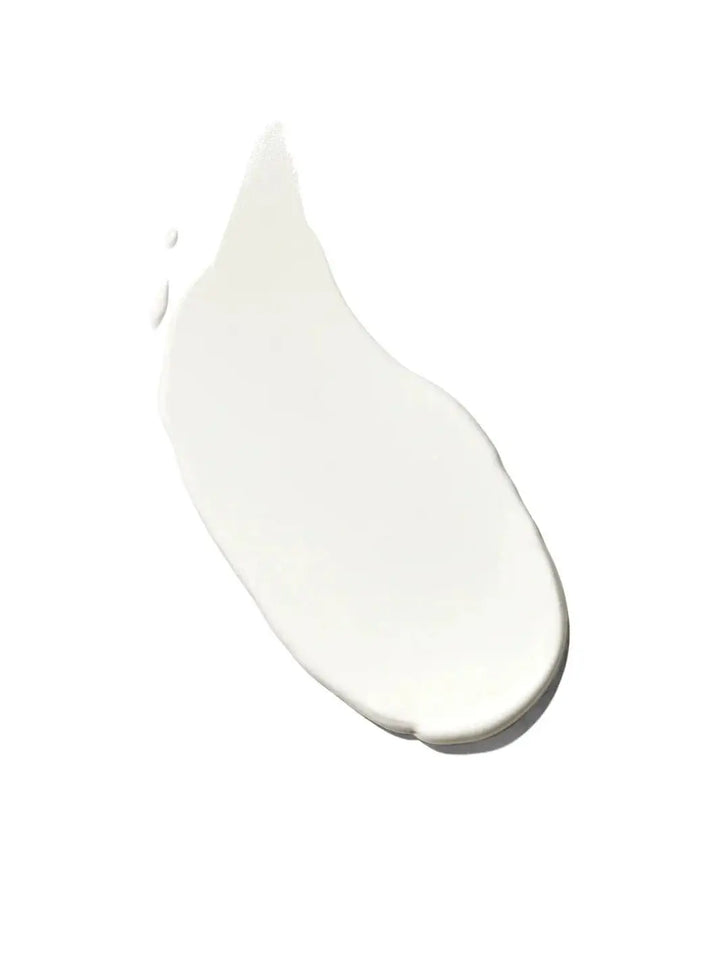 A smooth, thick swipe of white lotion demonstrates the lightweight texture of Bask Suncare Bask SPF 50 Lotion Sunscreen against a white background | Twentyseven Toronto