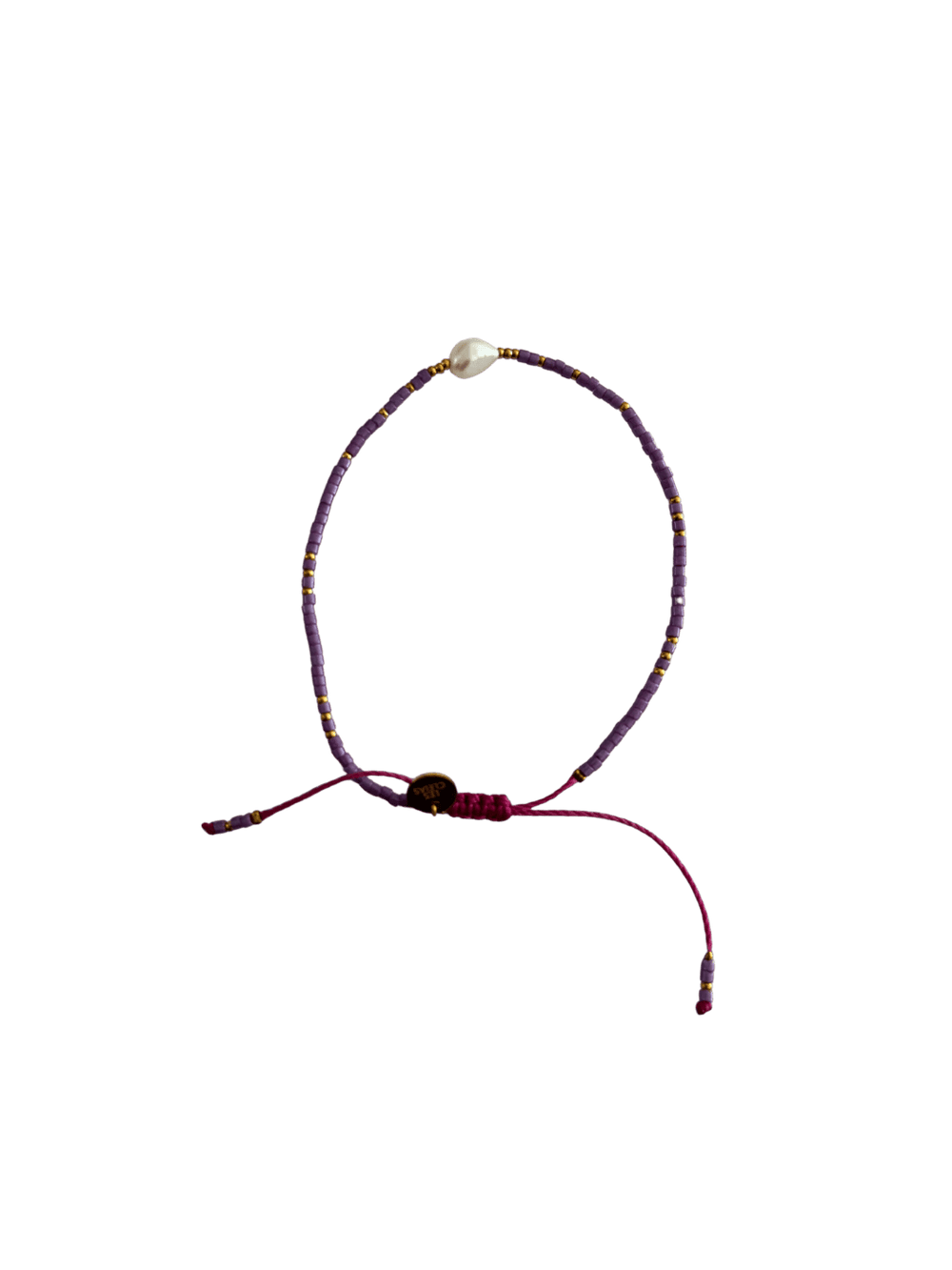 Bracelet with purple cord, small purple and gold beads and single white pearl with gold charm on a transparent background | Twentyseven Toronto