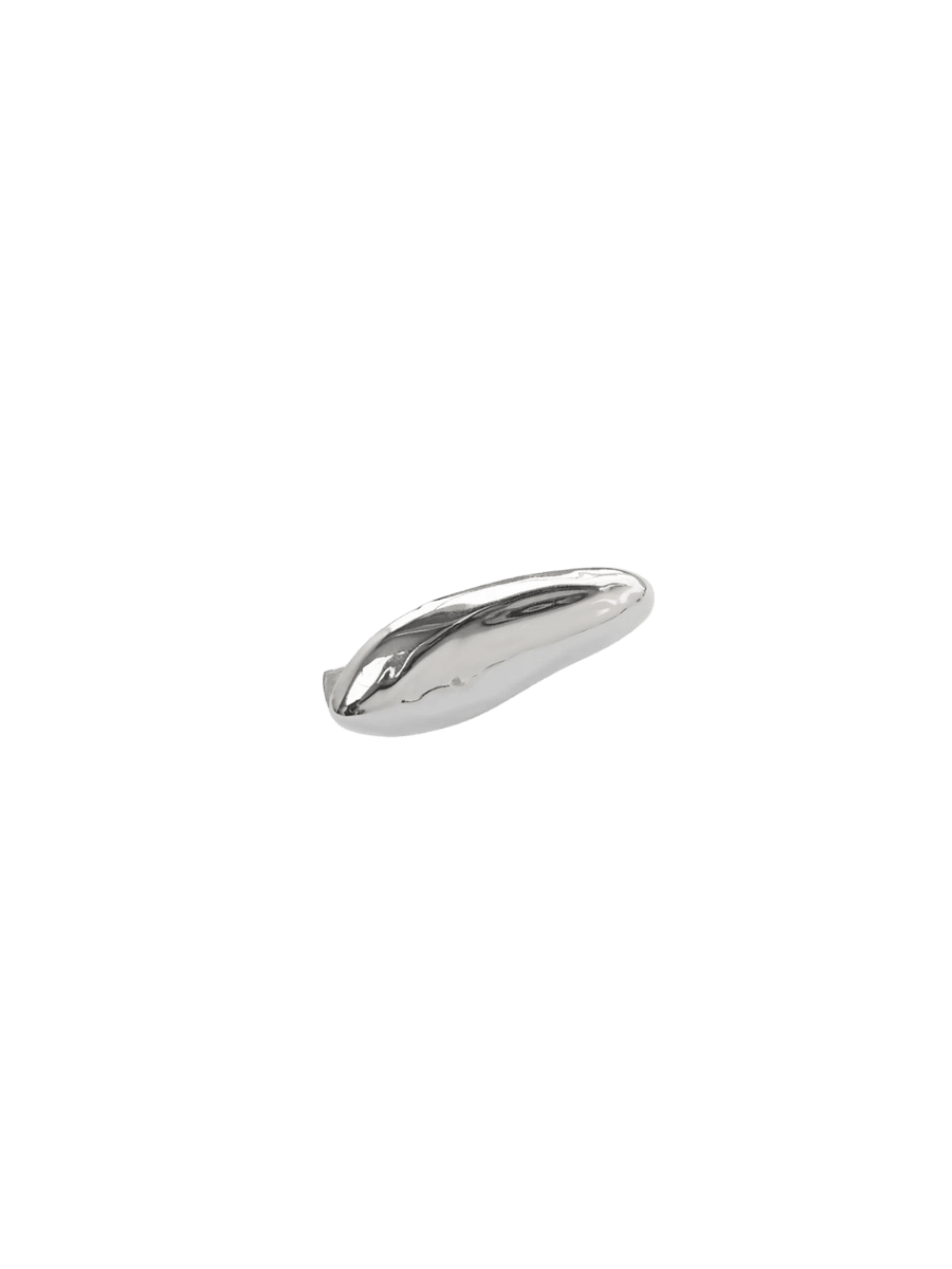 A smooth, silver, pebble-like silhouette of a single Bean Clip in Silver from Wolf Circus on a transparent background | Twentyseven Toronto