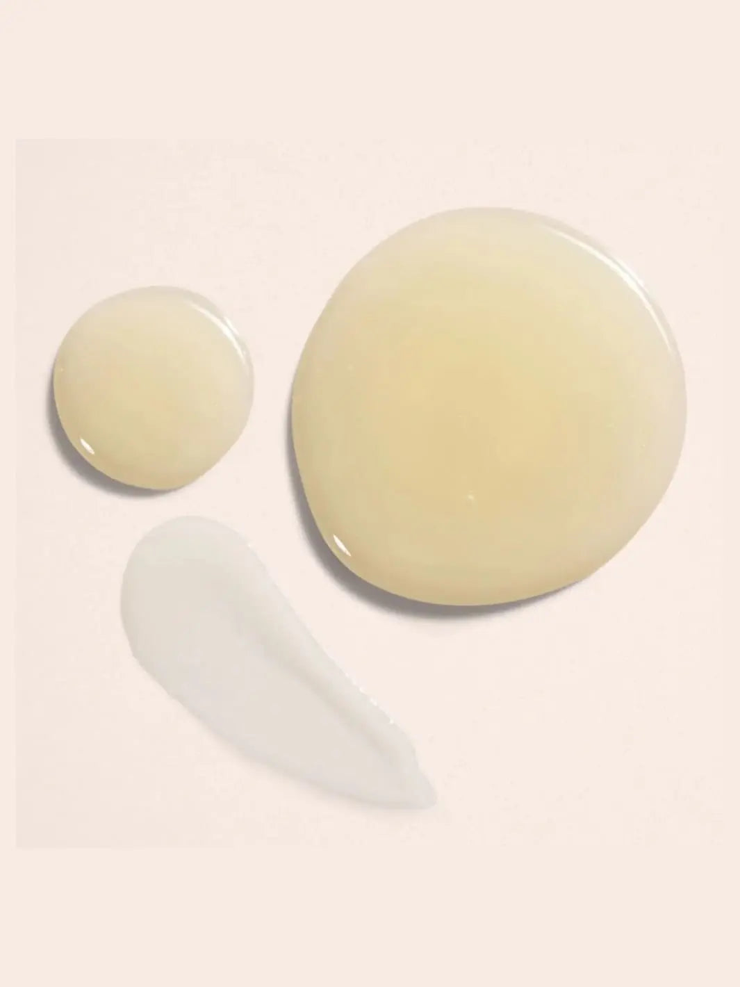 Beauty from Bees Body Serum | Twentyseven Toronto  | Drops of Beauty from Bees Body Serum on light pink background