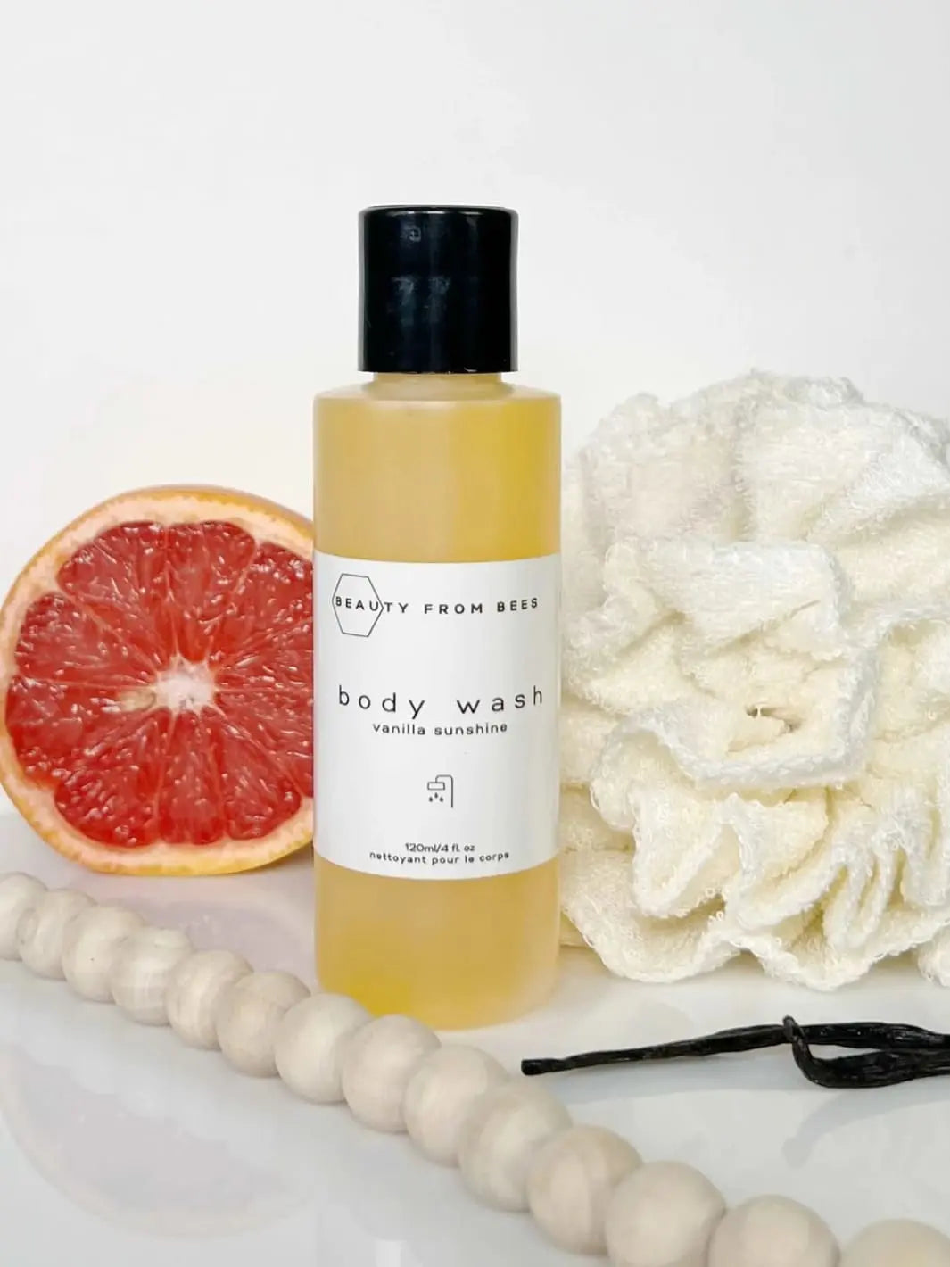 Beauty from Bees Body Wash | Twentyseven Toronto | Beauty from Bees Body Wash bottle with a grapefruit half and loofah
