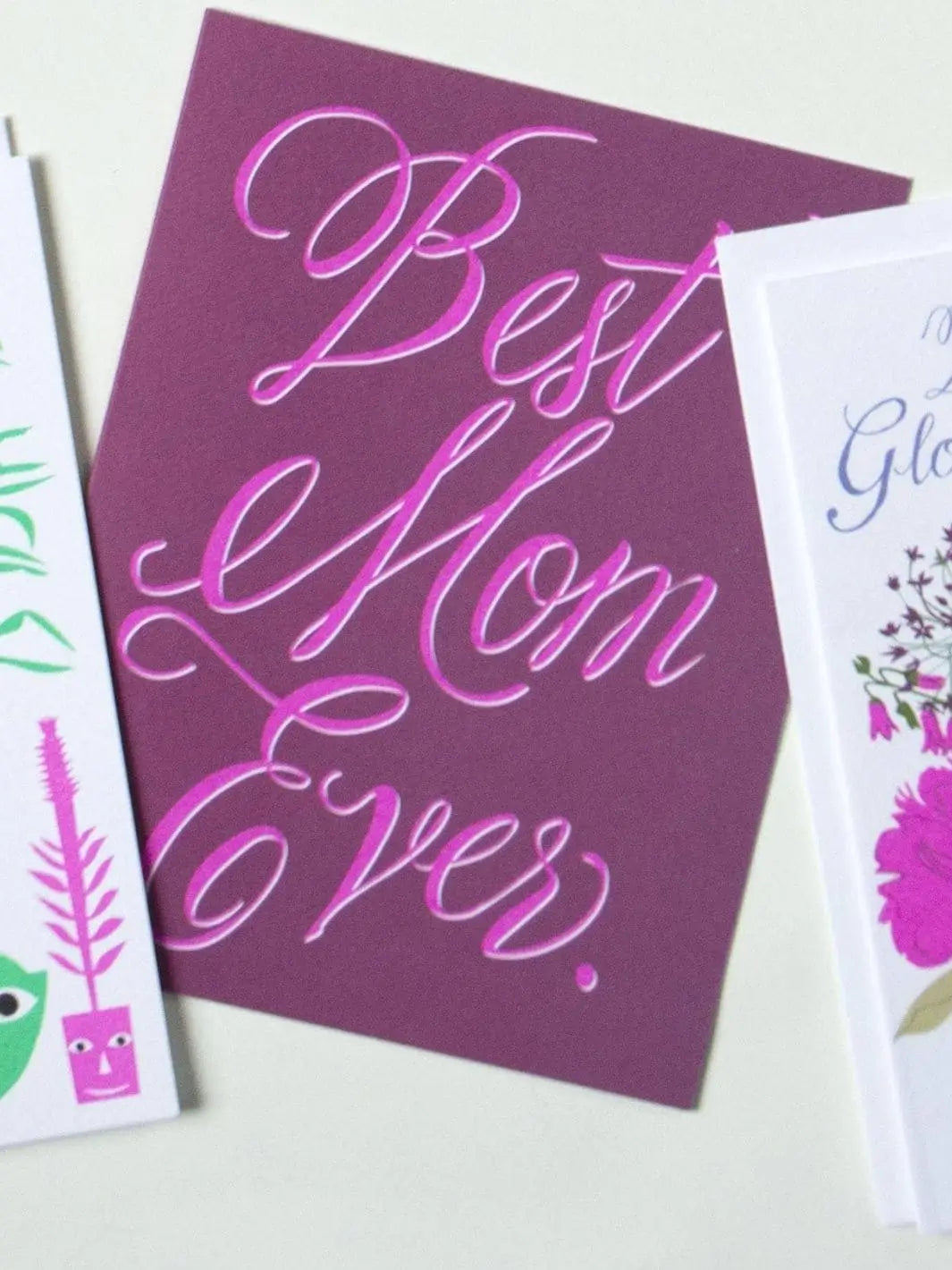 A mauve greeting card features elegant pink and white cursive lettering that reads "Best Mom Ever," showcasing the Banquet Workshop Best Mom Ever Note Card | Twentyseven Toronto