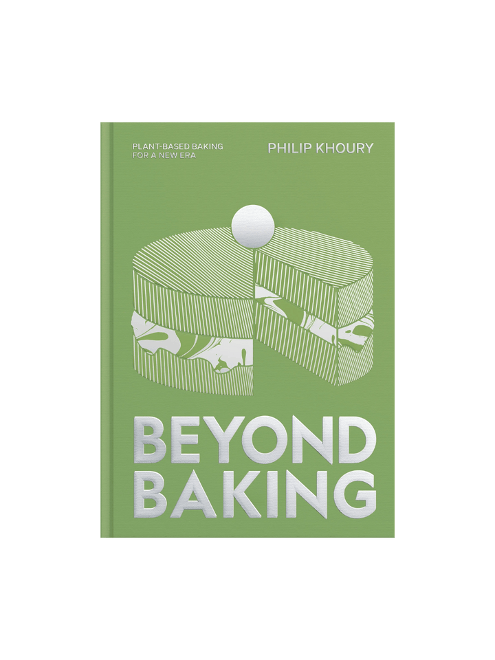 Front cover of Beyond Baking: Plant-Based Baking for a New Era by Philip Khoury, featuring a green background with a silver-foiled graphic of a layered cake and the title in large, bold silver letters | Twentyseven Toronto