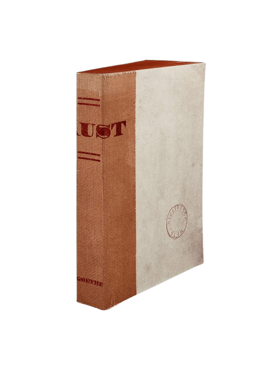 A notebook of Faust from the Slow Design Biblioteca Muta collection features a textured orange-brown gauze spine stamped with bold red typography next to a parchment-style cover bearing a circular library seal | Twentyseven Toronto