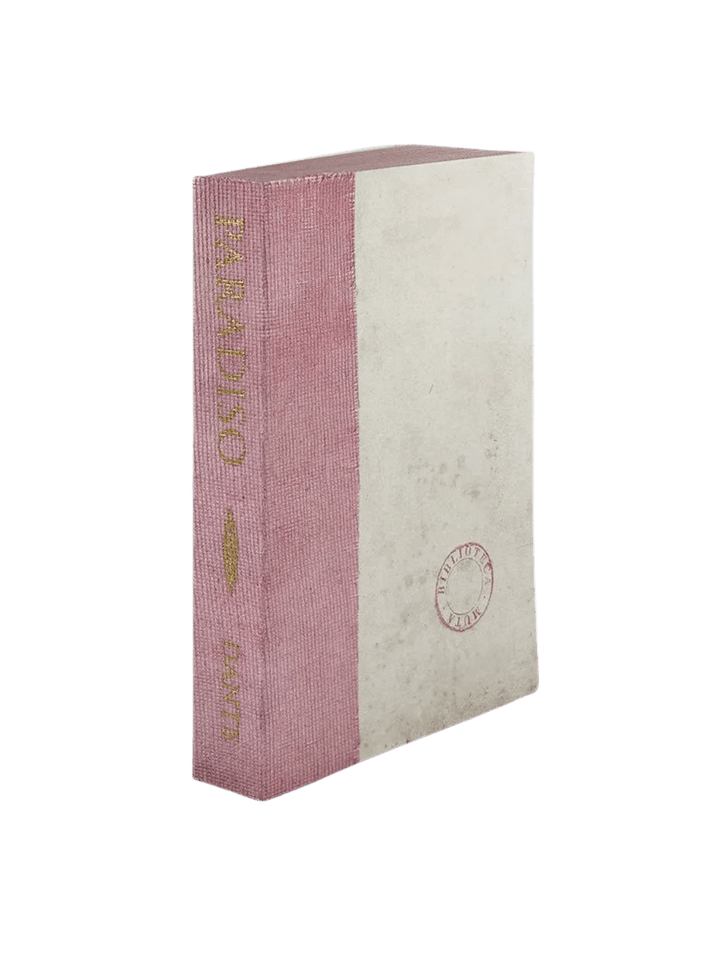 A notebook of Paradiso from the Slow Design Biblioteca Muta collection features a textured lavender-pink gauze spine stamped with elegant gold literary typography alongside a pale parchment-style cover bearing a circular library seal | Twentyseven Toronto