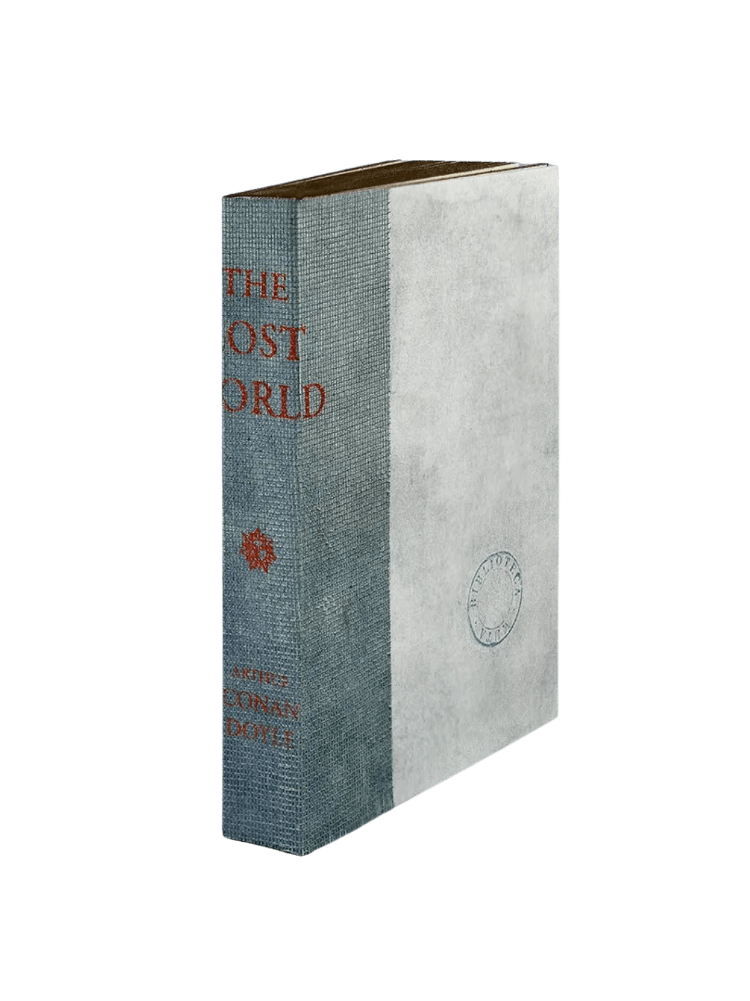 A notebook from the The Lost World from Slow Design Biblioteca Muta collection features a textured gray gauze spine stamped with orange literary typography alongside a parchment-style cover bearing a circular library seal | Twentyseven Toronto