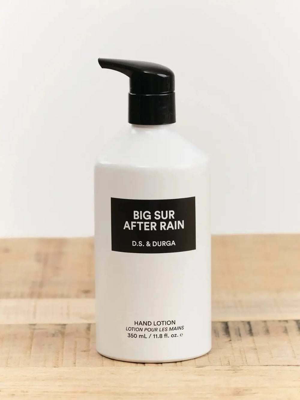 Hand lotion 350ml bottle labeled 'Big Sur After Rain' by D.S. & Durga on a wooden surface with a white background | Twentyseven Toronto