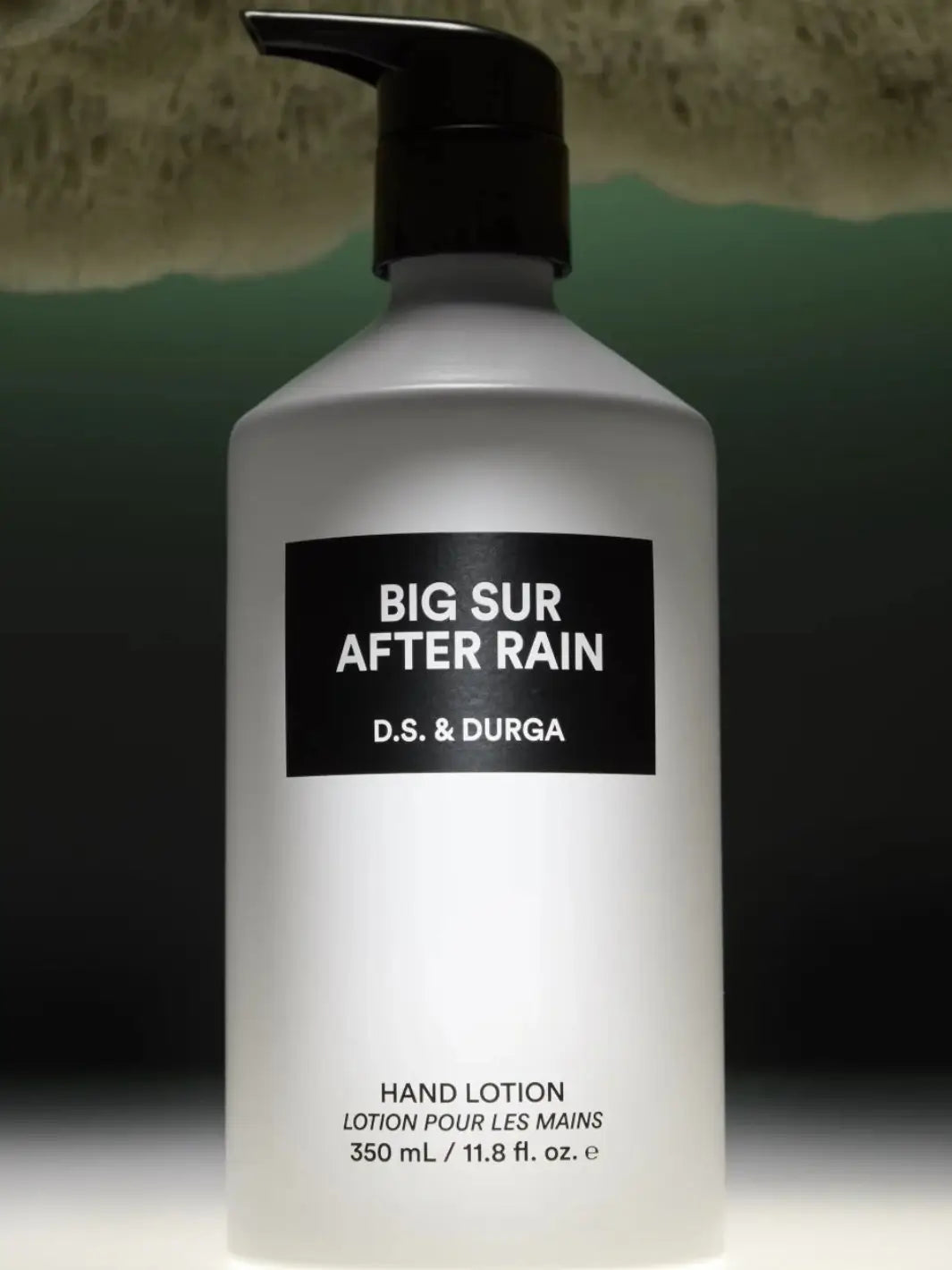 Hand lotion bottle labeled 'Big Sur After Rain' by D.S. & Durga on a dark background | Twentyseven Toronto