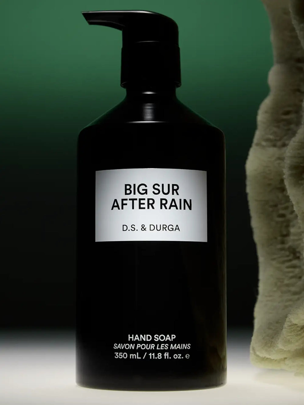 Black hand soap 350ml bottle labeled 'Big Sur After Rain' by D.S. & Durga on a dark green background | Twentyseven Toronto