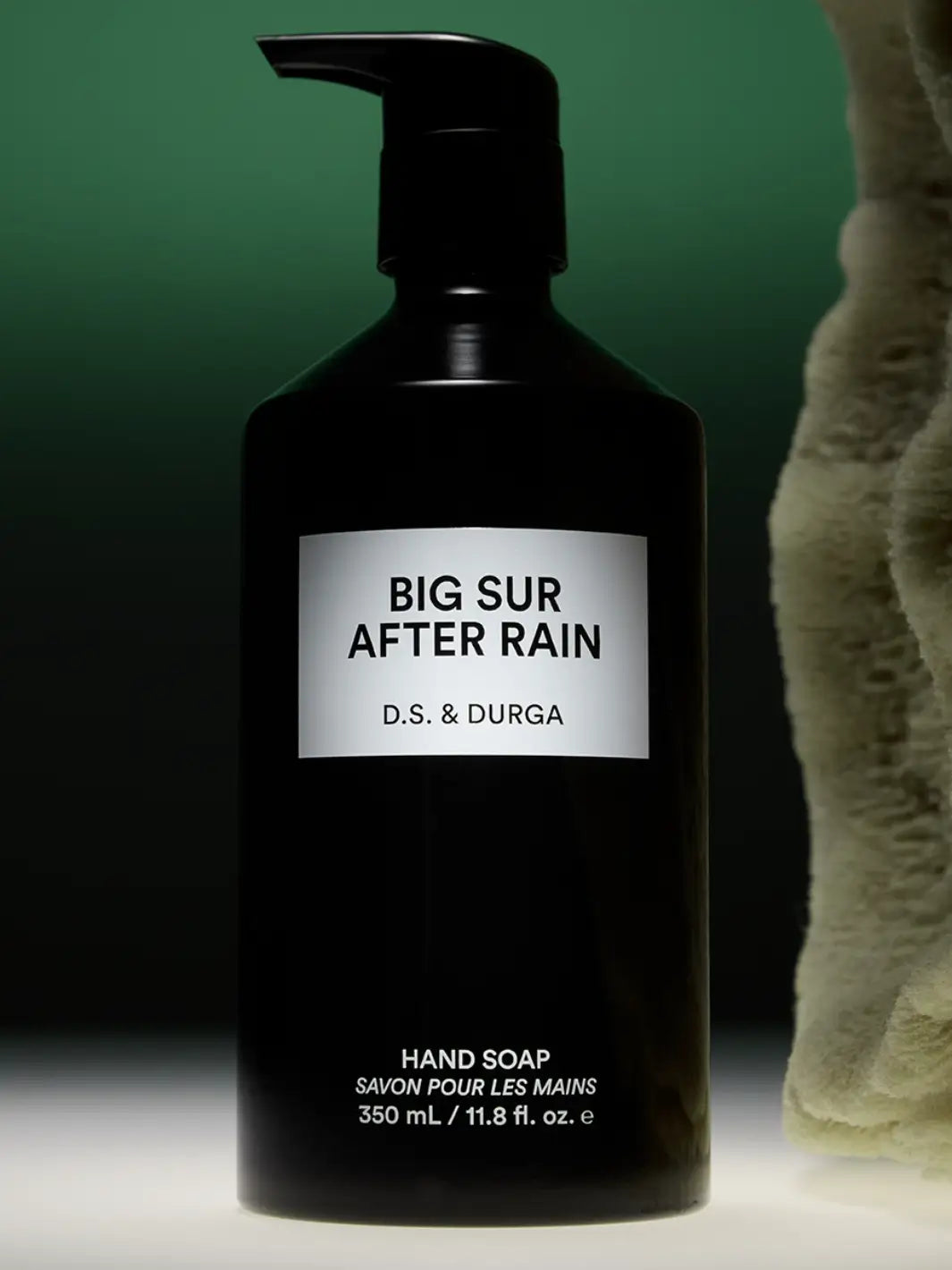 Black hand soap 350ml bottle labeled 'Big Sur After Rain' by D.S. & Durga on a dark green background | Twentyseven Toronto