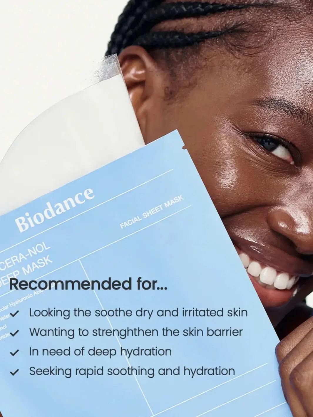 A close-up of a smiling woman holding up a blue Biodance Hydro Cera-nol Real Deep Sheet Mask package that lists recommended skin benefits, like soothing and deep hydration | Twentyseven Toronto