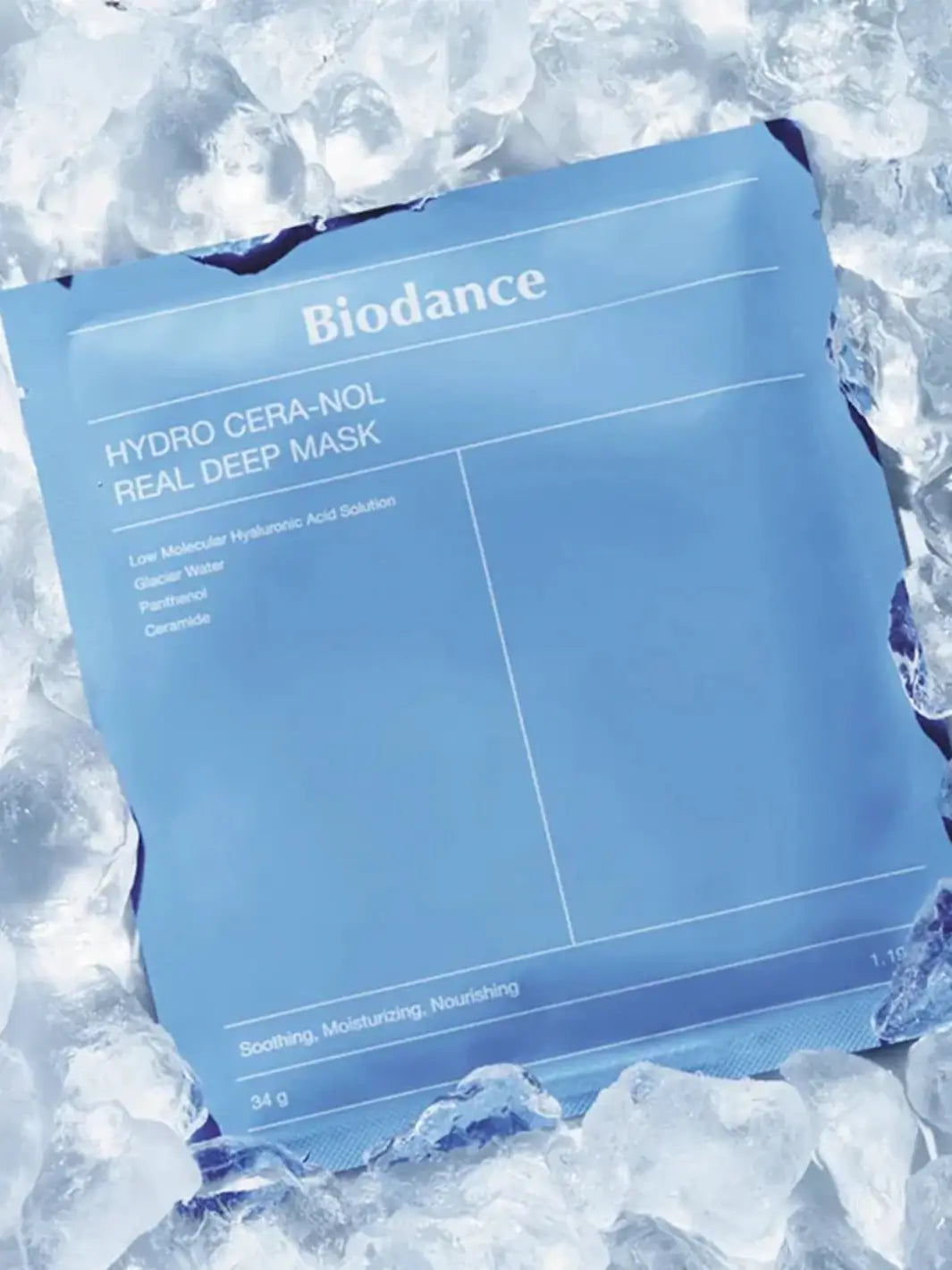 A blue package of the Biodance Hydro Cera-nol Real Deep Sheet Mask surrounded by and resting on a bed of crushed ice cubes to emphasize its cooling effect | Twentyseven Toronto