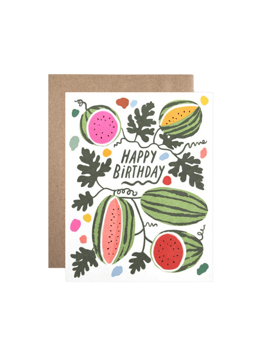 The Hartland Cards Birthday Watermelons Card features illustrated whole and sliced watermelons with pink, red, and yellow flesh growing on dark green vines, with "Happy Birthday" written in green in the center, paired with a brown kraft envelope | Twentyseven Toronto