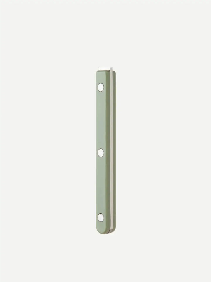 Side-view of the Sabre Paris Bistrot Solid Shiny Tart Server in Asparagus handle highlighting the vibrant light green acrylic finish and the signature triple-rivet detail | Twentyseven Toronto