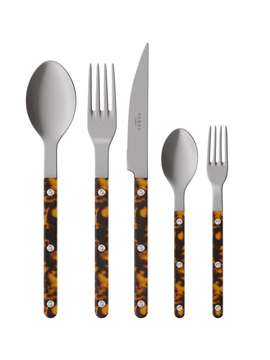The complete Sabre Paris Bistrot Vintage Finish 5 Piece Cutlery Set in Faux Tortoise including a soup spoon, a dinner fork, a serrated dinner knife blade, a teaspoon and a small fork | Twentyseven Toronto