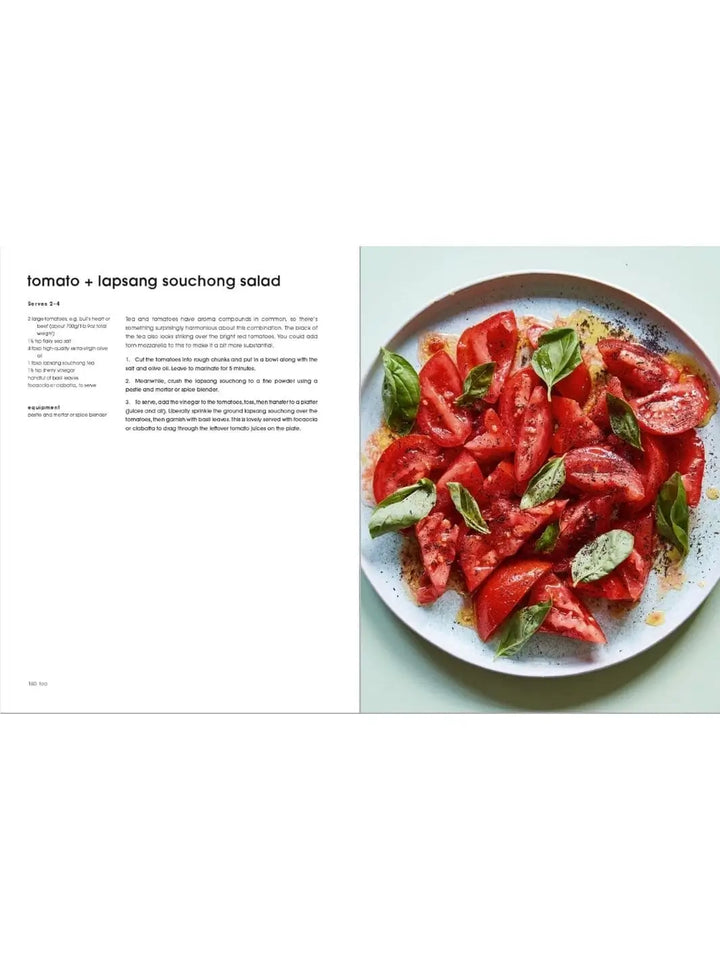 An open page from "Bitter by Alexina Anatole" shows a recipe text opposite a white plate piled high with a refreshing tomato and lapsang souchong salad garnished with fresh basil leaves | Twentyseven Toronto