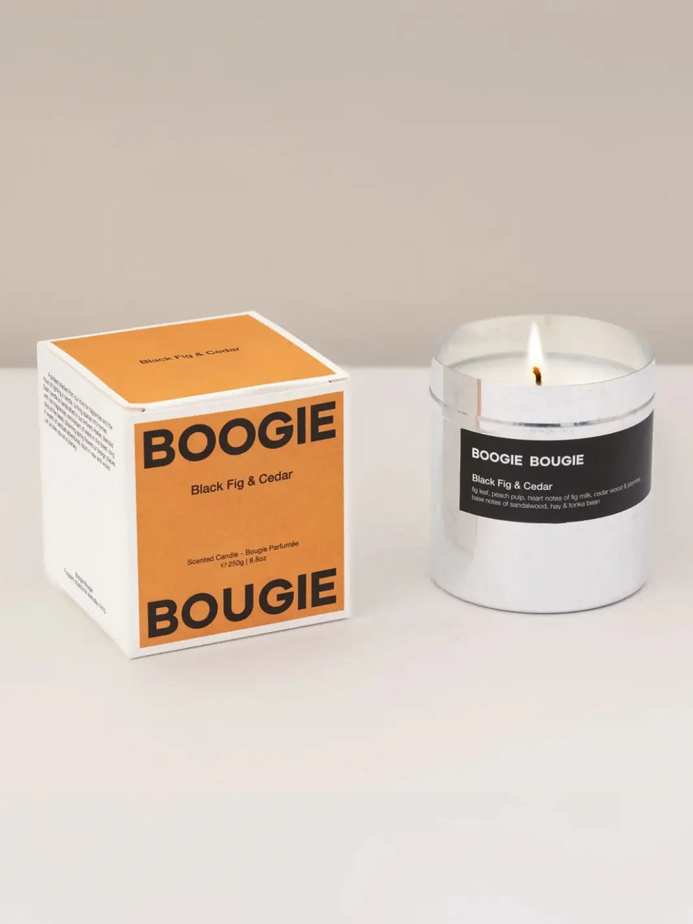 Boogie Bougie Black Fig and Cedar candle and orange packaging on a white background | Twentyseven Toronto