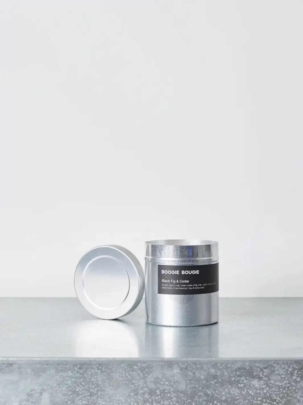 Silver cylindrical candle tin in 'Black Fig and Cedar' scent with a 'Boogie Bougie' label on a light gray background | Twentyseven Toronto