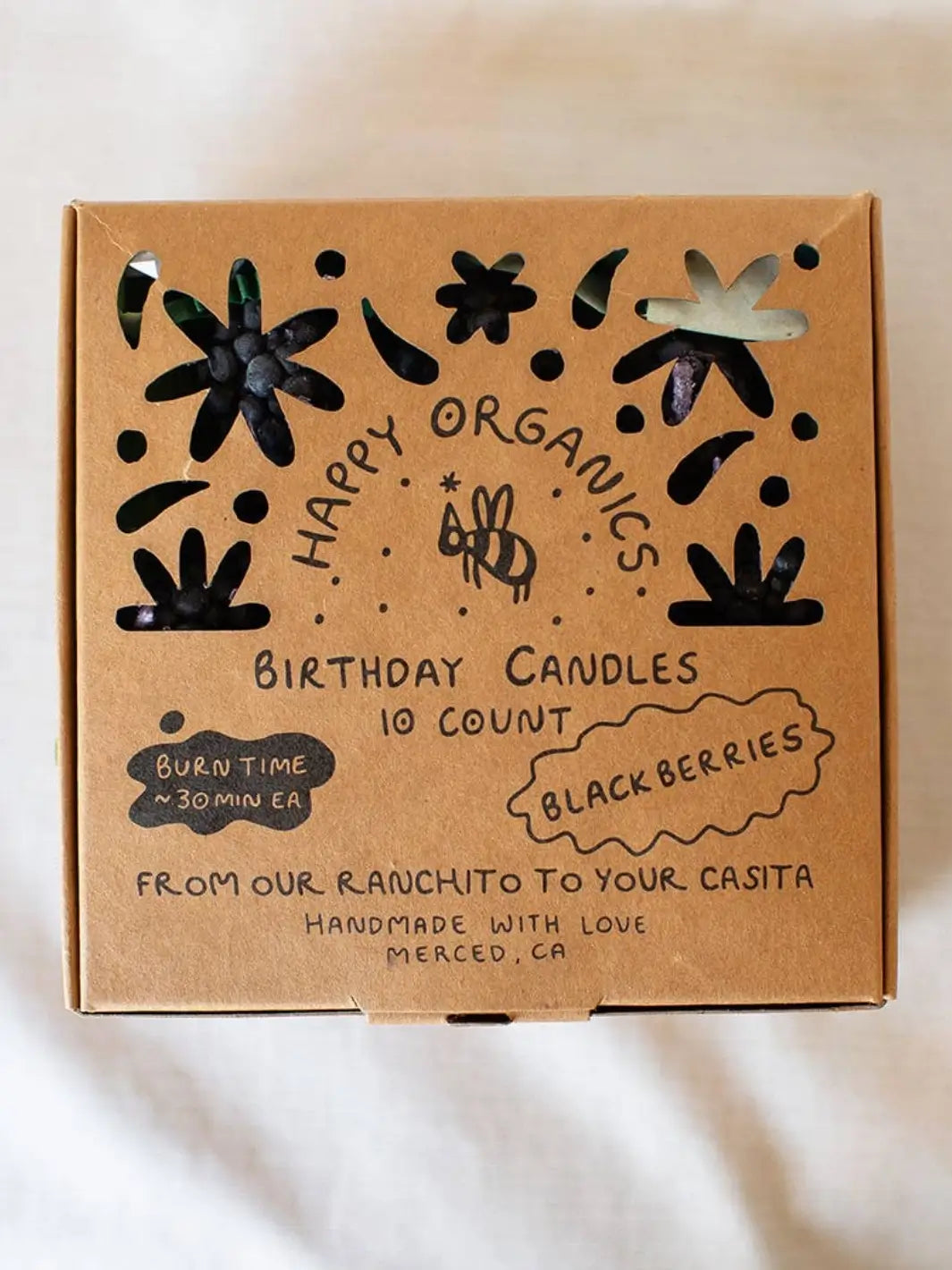 Box of Happy Organics blackberry birthday candles with decorative elements on a white background | Twentyseven Toronto