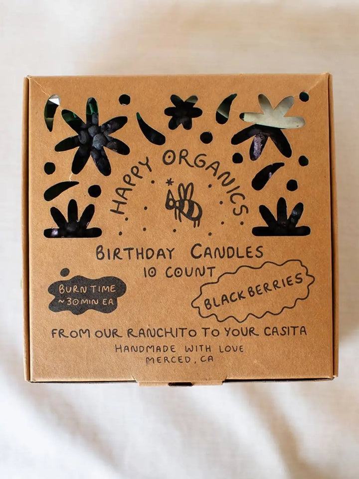 Box of Happy Organics blackberry birthday candles with decorative elements on a white background | Twentyseven Toronto