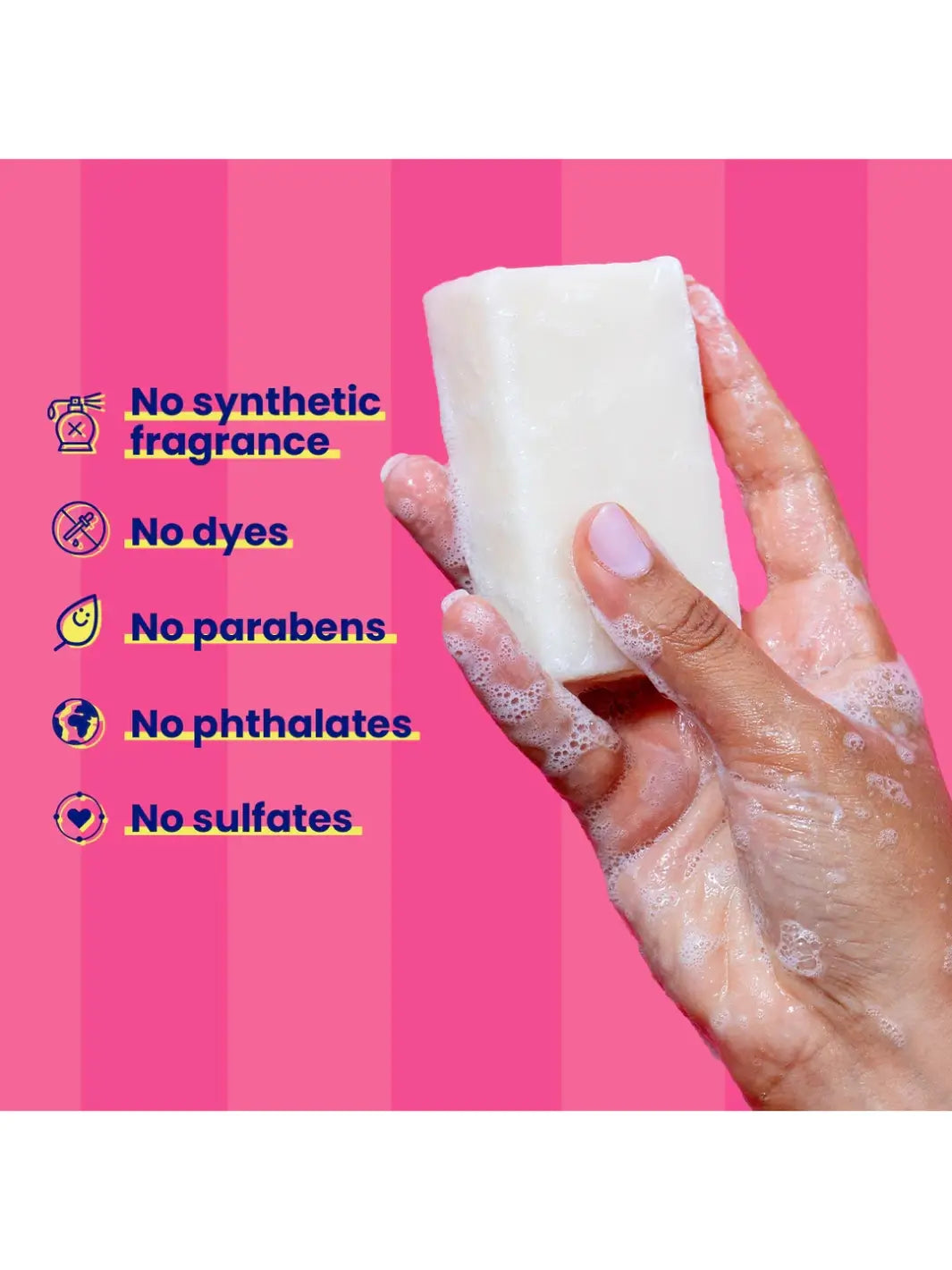 Hand holding a 'Blade Bar' soap from Megababe with a pink background and text about product ingredients | Twentyseven Toronto
