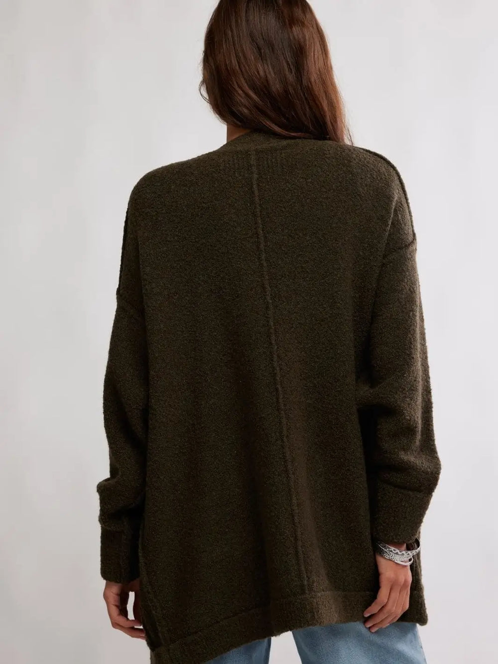 A rear view captures the dropped shoulders and clean center-back seam detailing of the longline Free People Blazing Cardi in Dark Green | Twentyseven Toronto