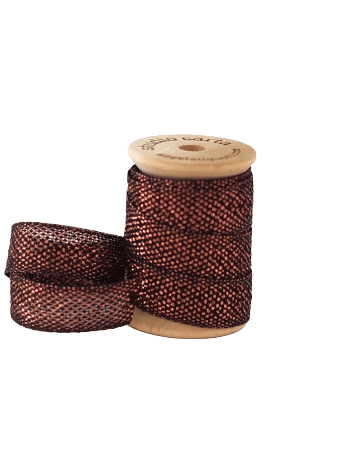 Studio Carta Metallic Loose Weave Ribbon in Black/Copper wrapped around a wooden spool with ribbon unfurled | Twentyseven Toronto