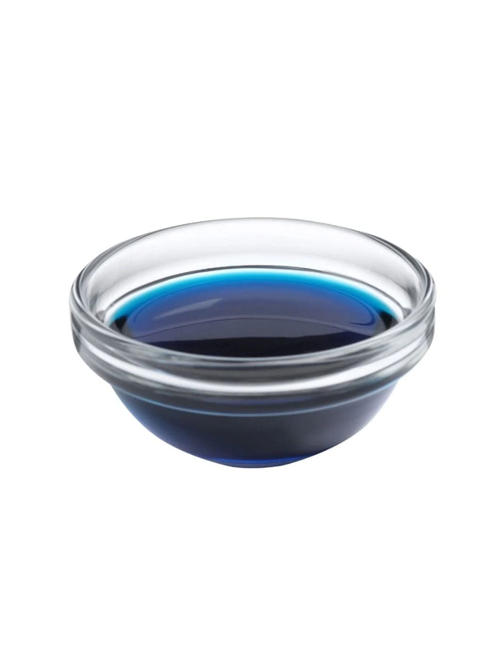 Clear glass bowl filled with blue oil from WOO World of Oils on a white background | Twentyseven Toronto