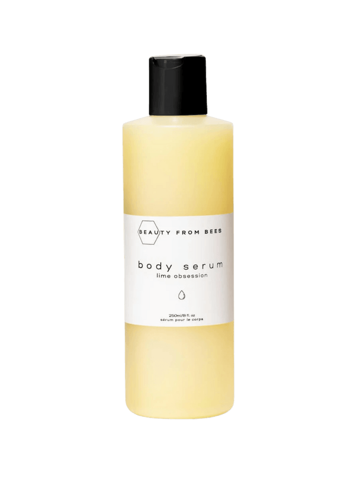 A studio product shot of a bottle of Beauty from Bees Body Serum in Lime Obsession with a black cap | Twentyseven