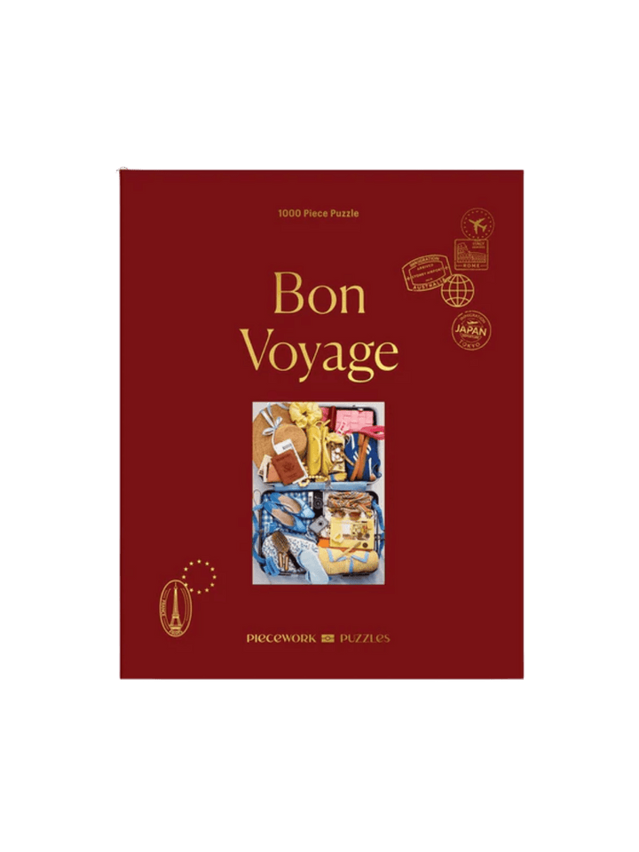 The Piecework Puzzles Bon Voyage 1000 Piece Puzzle features its classic dark red box cover | Twentyseven Toronto