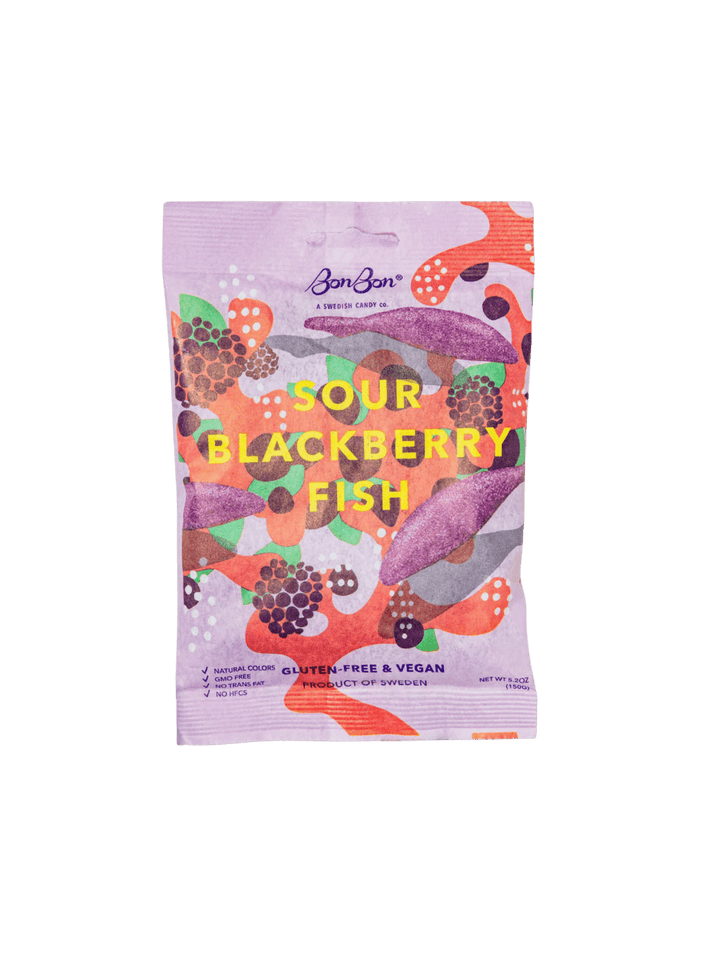 A stand-up pouch of BonBon Sour Blackberry Fish snack, featuring a colorful illustration of fish and blackberries on a light pink background | Twentyseven Toronto