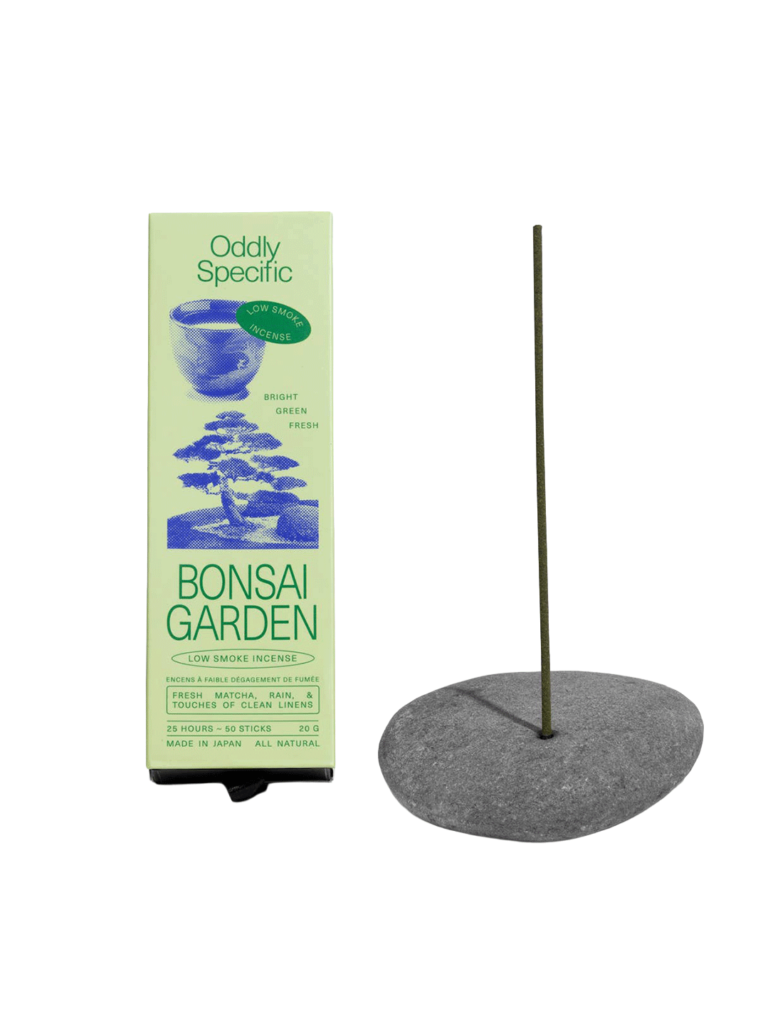 Oddly Specific Bonsai Garden Low Smoke Incense in light green packaging with blue Japanese garden illustrations, displayed beside a green incense stick in a grey stone holder | Twentyseven Toronto
