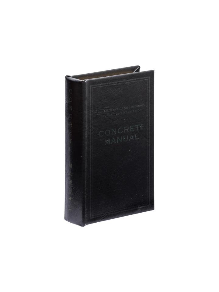 The Book Box - Concrete Manual BK from Puebco replicates a vintage technical manual with its black leatherette texture and dark debossed lettering | Twentyseven Toronto