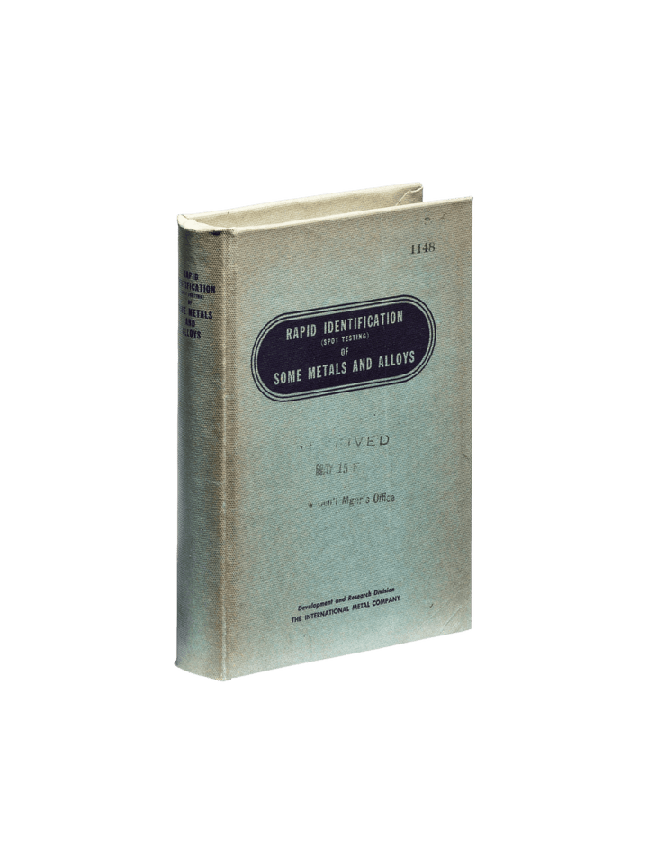 The front cover of the vintage-style Book Box - Metals and Alloys from Puebco features industrial text reading "Rapid Identification of Some Metals and Alloys" against a transparent background | Twentyseven Toronto